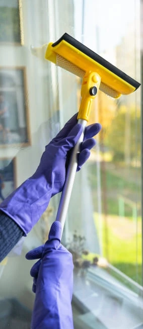 Cleaner wiping down a wall-mounted TV unit